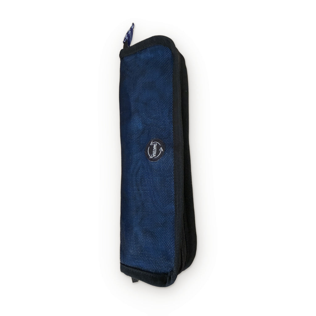 Smateria Buoy toiletry organiser in Dark Blue, angled view showing its slim, packable shape