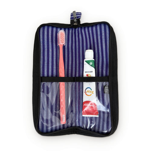 Smateria Buoy toiletry organiser unzipped flat, holding a toothbrush and toothpaste against the striped lining