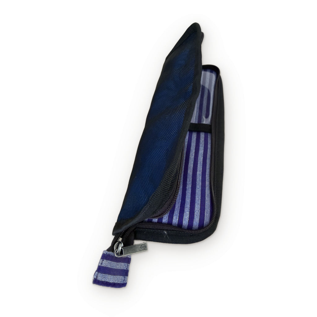 Smateria Buoy toiletry organiser half unzipped, showing the striped lining made from industrial textile waste and the woven zip pull